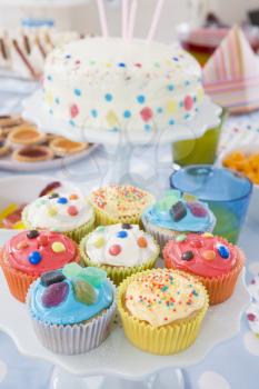 Royalty Free Photo of Birthday Cupcakes and Cake