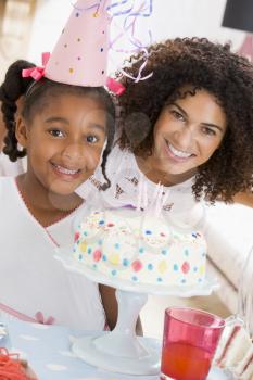 Royalty Free Photo of a Mother and Daughter With Birthday Cake