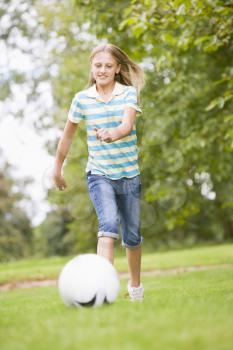 Royalty Free Photo of a Girl Playing Soccer