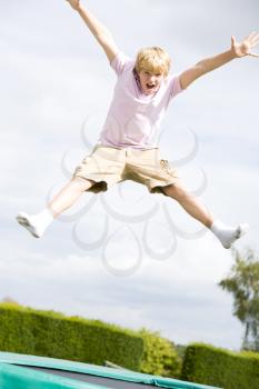 Royalty Free Photo of a Boy on a Trampoline