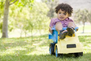 Royalty Free Photo of a Boy Playing In a Toy Dump Truck
