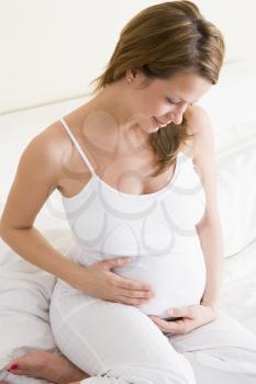 Royalty Free Photo of a Pregnant Woman Holding Her Stomach