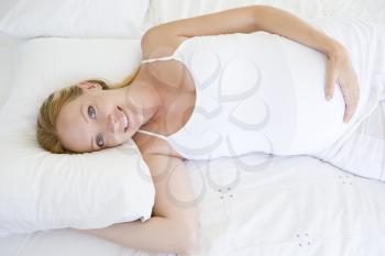 Royalty Free Photo of a Pregnant Woman in Bed