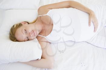 Royalty Free Photo of a Pregnant Woman Sleeping