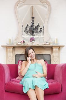 Royalty Free Photo of a Pregnant Woman on the Telephone