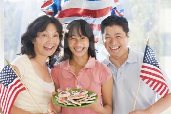 Royalty Free Photo of a Family With Cookies and American Flags