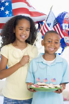 Royalty Free Photo of a Children With American Flags and Cookies