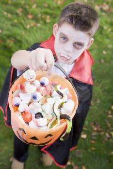 Royalty Free Photo of a Boy in a Vampire Costume With Treats