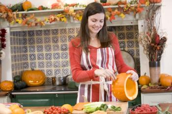 Royalty Free Photo of a Woman Carving a Pumpkin