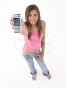 Young girl holding up cellular phone and smiling