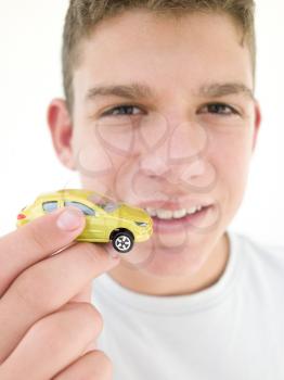 Royalty Free Photo of a Boy Holding a Toy Car