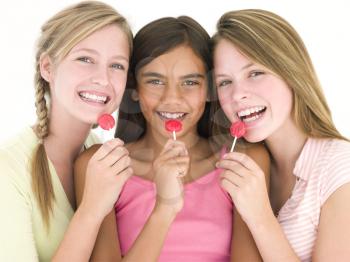 Royalty Free Photo of Three Girls With Suckers