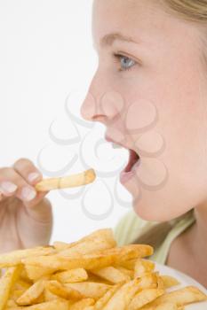 Royalty Free Photo of a Girl Eating French Fries