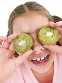 Royalty Free Photo of a Girl With Kiwi Over Her Eyes