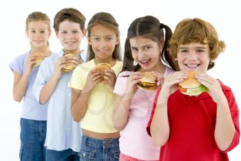 Royalty Free Photo of Five Children in a Row Eating Burgers