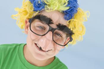 Royalty Free Photo of a Boy in a Wig and Fake Glasses and Nose