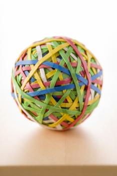 Royalty Free Photo of a Rubber Band Ball on a Desk