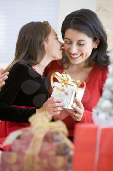 Royalty Free Photo of a Girl Giving Her Mom a Kiss and a Gift