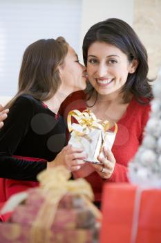 Royalty Free Photo of a Girl Giving Her Mom a Kiss and a Gift