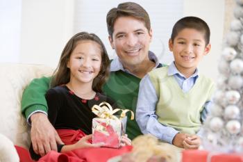 Royalty Free Photo of a Father With His Children at Christmas