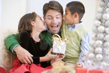 Royalty Free Photo of a Father Getting a Gift From His Children