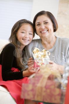Royalty Free Photo of a Grandmother and Granddaughter With a Christmas Gift