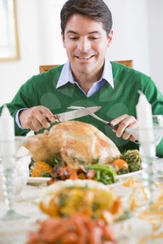 Royalty Free Photo of a Man Carving a Christmas Turkey