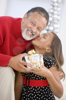 Royalty Free Photo of a Grandfather and Granddaughter With a Gift