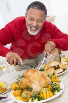 Royalty Free Photo of a Man Carving a Roast Turkey