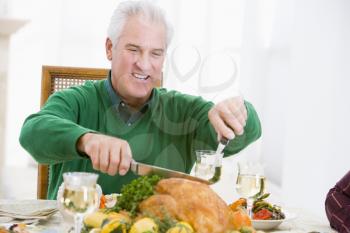 Royalty Free Photo of a Man Carving a Turkey