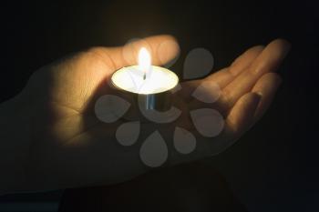 Royalty Free Photo of a Candle in the Palm of a Hand