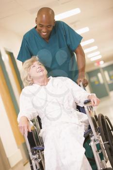 Royalty Free Photo of an Orderly With a Woman in a Wheelchair