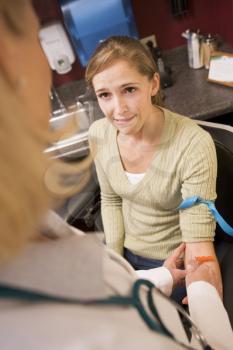 Royalty Free Photo of a Girl Having a Blood Test