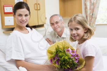 Royalty Free Photo of a Father and Daughter Visiting a Mother in the Hospital