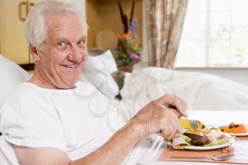 Royalty Free Photo of a Man in the Hospital Eating a Meal