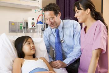 Royalty Free Photo of a Doctor and Nurse With a Young Patient