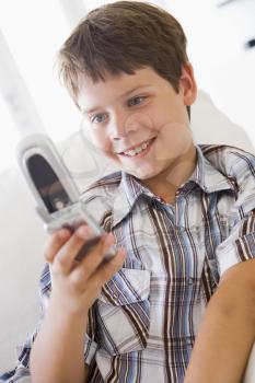 Royalty Free Photo of a Young Boy Texting