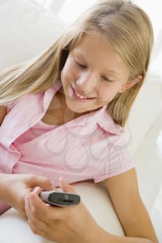 Royalty Free Photo of a Young Girl Sending a Text Message