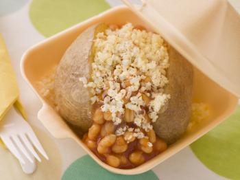 Royalty Free Photo of a Baked Potato With Baked Beans And Cheese In A Take Away Box