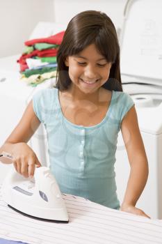 Royalty Free Photo of a Little Girl Ironing