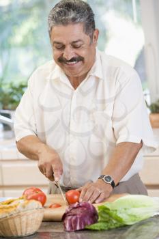 Royalty Free Photo of a Man Chopping Vegetables