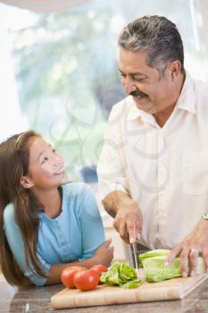 Royalty Free Photo of a Grandfather and Granddaughter Preparing a Meal
