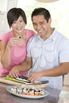 Royalty Free Photo of a Couple Preparing Sushi