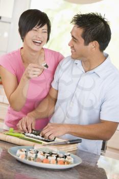 Royalty Free Photo of a Couple Preparing Sushi