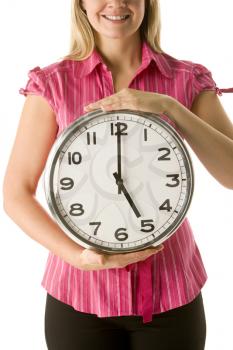 Royalty Free Photo of a Woman Holding a Clock