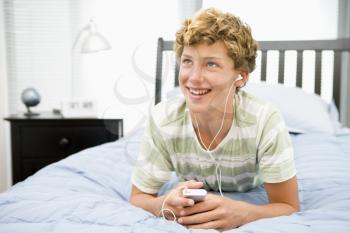 Royalty Free Photo of a Boy Listening to His MP3 Player