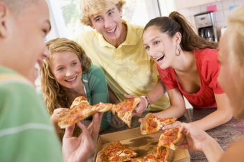 Royalty Free Photo of Teens Eating Pizza