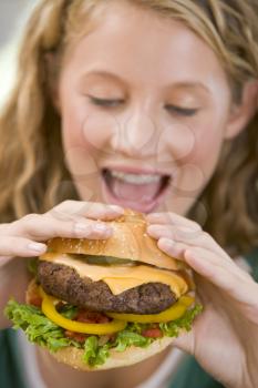 Royalty Free Photo of a Girl Eating a Burger