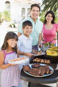 Royalty Free Photo of a Family Barbecuing