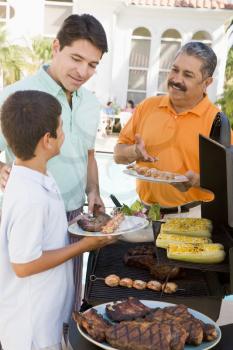 Royalty Free Photo of Three Generations of Men Barbecuing